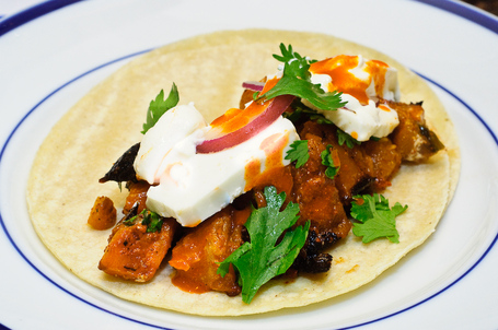 The butternut squash tacos with queso panella, onions, cilantro and hot sauce